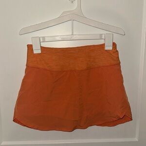 Orange tennis skirt with built in shorts